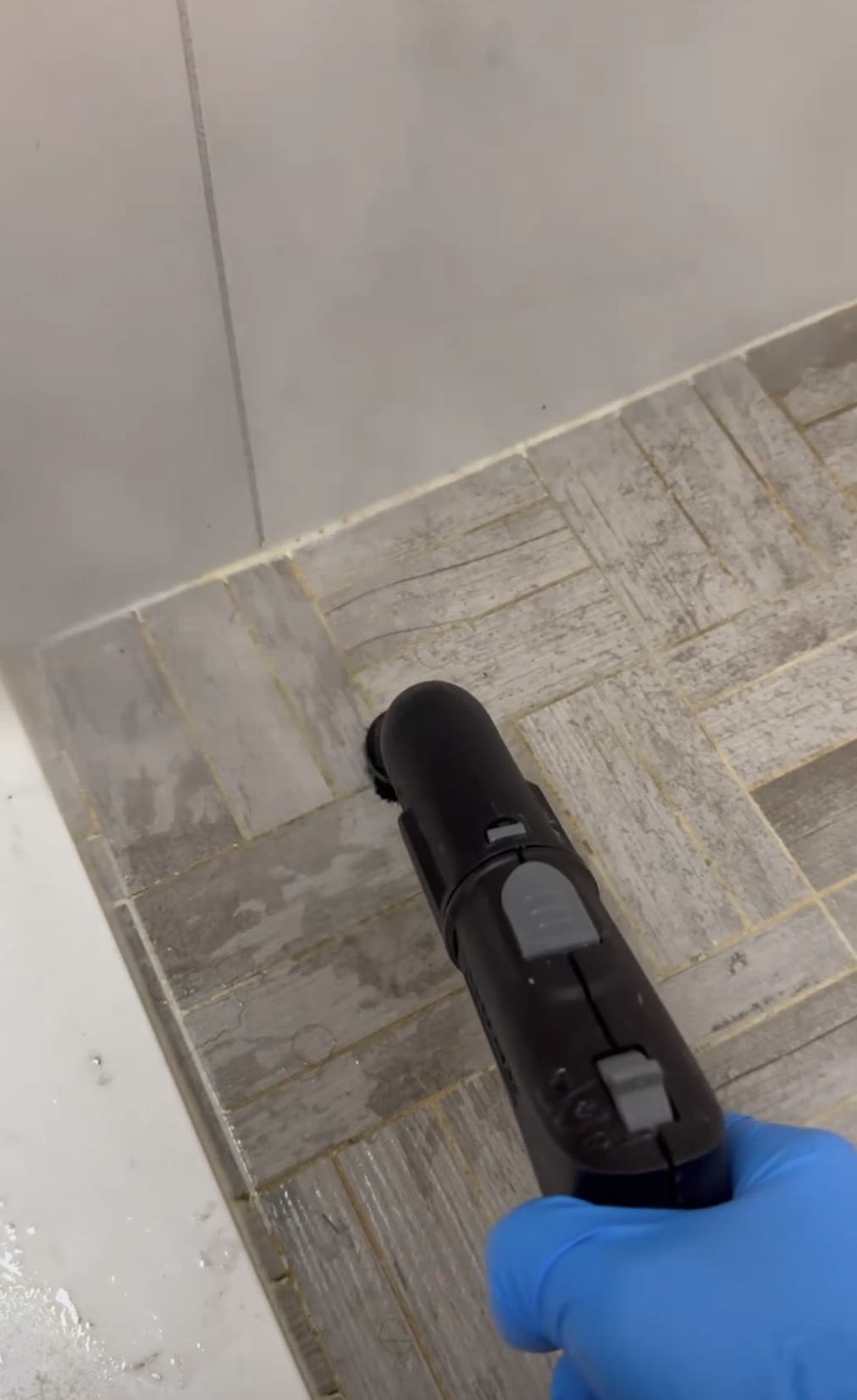 Steam detail cleaning shower floor and grout